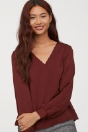  Blusa con escote de pico 15.99 €
